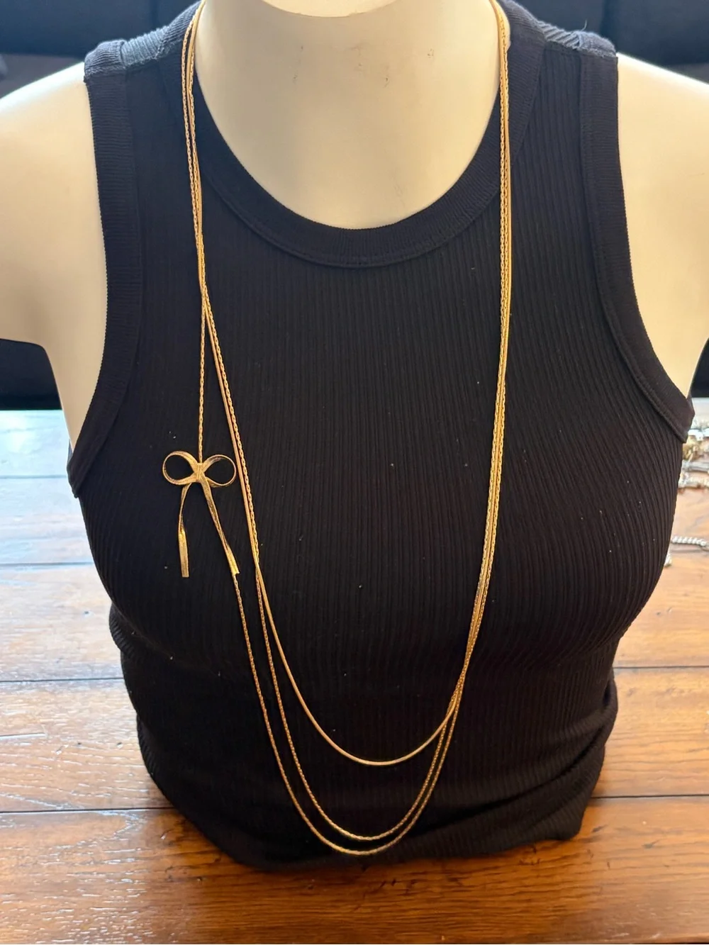 Candie's Long Multi-Strand Gold Tone Necklace with Bow Pendant
